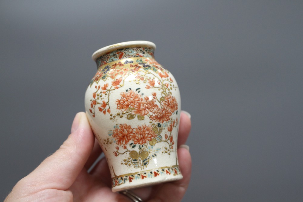 A small Cantonese porcelain teapot, a Satsuma vase, a silkwork panel, a doll and a broken soapstone figure